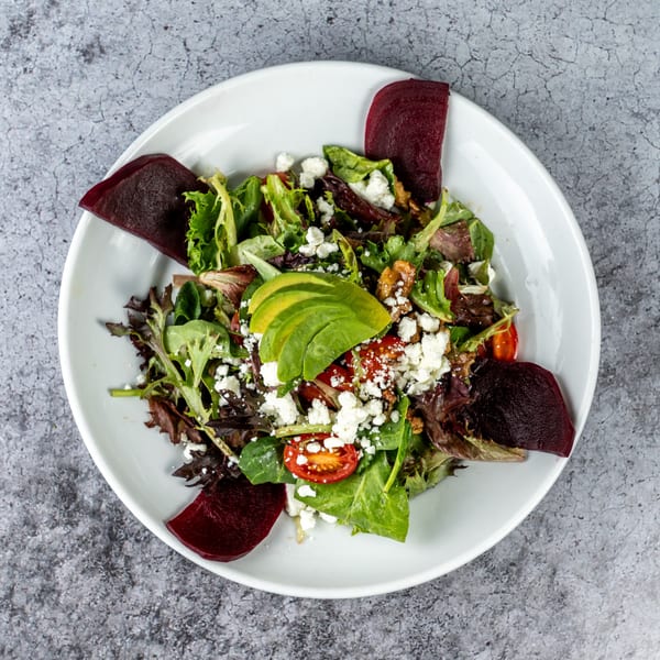 Barrel 28's vibrant salad with mixed greens, avocado, tomatoes, feta, walnuts, and beets.